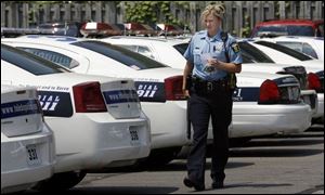 A Toledo officer leaves the Northwest District Police Station yesterday. Its patrol officers will work from the other stations.
