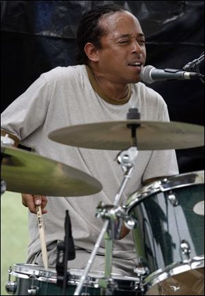 Drummer Damen Cook of the Gene Parker Quartet plays some blue notes during this year's blues festival downtown at Festival Park. In addition to music, the waterfront festival also features summer cuisine.