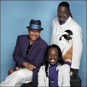 Earth, Wind & Fire, featuring, clockwise from bottom, Verdine
White, Ralph Johnson, and Philip Bailey, will perform tonight at
the Toledo Zoo Amphitheater.