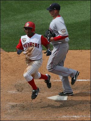 Freddy Guzman scores the winning run in the 12th inning when Pawtucket pitcher Lincoln Holdzkom threw a wild pitch for strike three.