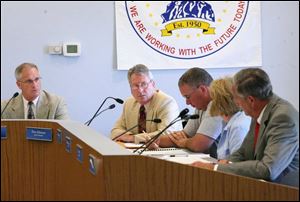 Anthony Wayne Superintendent John Granger, far left, speaking to school board members, from left, Don Atkinson, Doug Zimmerman, Pam Gerhardinger, and Gary Roser, says the district has cut $2 million from its operating budget since 2006 and has left 29 positions vacant to save money.