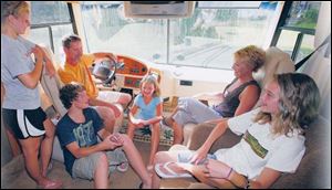 Jody McCollum, seated at the wheel, with daughter Taylor, 16, standing at left; daughter Abby, 8; wife Kathy; daughter Torie, 14, and son Logan, 12.