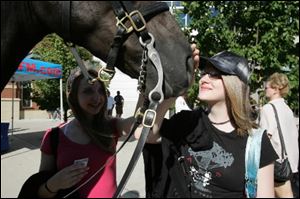 Mandy Herring-Orley, 17, left, and her friend Mary Olesky say hello to Renegade.