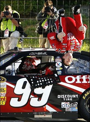 Carl Edwards celebrates winning the 500-mile race at Pocono Speedway yesterday with his trademark backflip.