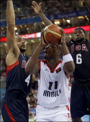 Angola's Felizardo Ambrosio, center, is double-teamed by 
Carlos Boozer, left, and LeBron James of the United States.