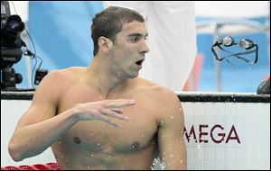Michael Phelps tosses his goggles after setting a world record and winning the gold medal in the 200-meter butterfly. (ASSOCIATED PRESS)
<br>
<img src=http://www.toledoblade.com/graphics/icons/video.gif> <b><font color=red>VIDEO</b></font color=red>: <a href=