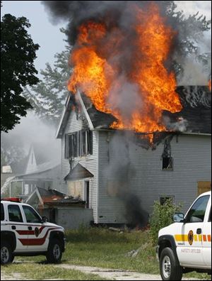 CTY fire12p  Toledo Firefighters contain a fire in an unoccupied two-storey house on Georgia just west of  Upton in Toledo, Ohio on August 12, 2008. According to TFD Lt. Kevin Gordon, the house was not safe to enter, so they were fighting the fire from just the outside, working to keep it from spreading to nearby, also vacant houses.    The Blade/Jetta Fraser