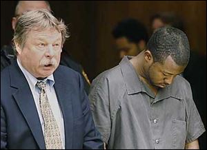 Public defender James MacHarg, left, and Anthony Belton at Belton's arraignment for the murder of and aggravated robbery Friday.