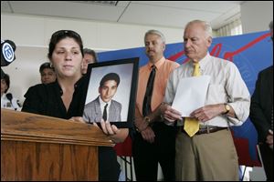 Molly Dugan, a sister of the slain worker, thanks police along with Detective Jeff Clark and Mayor Carty Finkbeiner.
