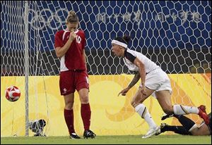 he United States' forward Natasha Kai, right, scores the team's second goal during the extra time of the women's quarter final match between USA and Canada at the Beijing 2008 Olympics in Shanghai, Friday