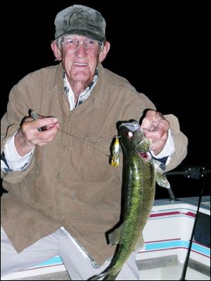 Tom 'Turtle Man' Frisch shows off one of the walleye he hooked off a near-shore reeftop in western Lake Erie. Andrea Cromley, 9, of Bowling Green, with a little help from her brother, Mitch, shows off a 29-inch walleye she landed.