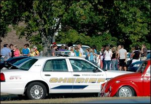 Students and staff gather outside Central High School in Knoxville, Tenn., after Ryan McDonald, a sophomore, was fatally shot in the school's cafeteria early yesterday morning.