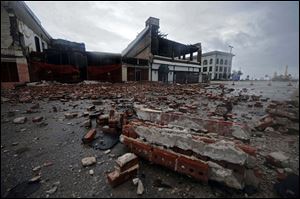 Large pieces of brick from a building in downtown Gulfport, Miss., which was damaged three years ago by Hurricane Katrina, is knocked down by winds from Hurricane Gustav on Monday.