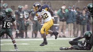 Toledo running back DaJuane Collins powers through a hole against Eastern Michigan. He gained 168 yards on 19 carries in only three quarters as the Rockets rolled to an easy win.
