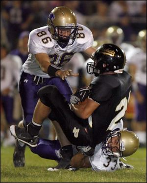 Maumee s Brian Rahman (86) and Mike Wilkins combine to bring down Perrysburg s Taylor Dimmerling last night.
<BR>
<img src=http://www.toledoblade.com/graphics/icons/photo.gif> <b>HIGH SCHOOL FOOTBALL WEEK 5:</b> View <a href=http://www.toledoblade.com/apps/pbcs.dll/gallery?Avis=TO&Dato=20080920&Kategori=SPORTS12&Lopenr=920009998&Ref=PH><b><font color=red> Maumee - Perrysburg </font color=red> </b></a> football photo gallery