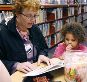 CTY record03p   Anne Norman, left, reads 