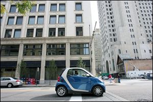 Wayne Anthony stops his Smart Car on Superior Street downtown. The car measures 104 inches long. 
