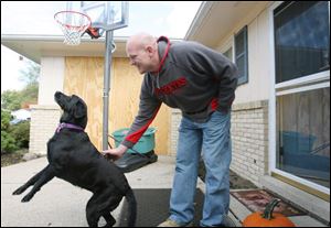 'Joe the Plumber' Wurzelbacher plays with his dog Abby at his home on Shrewsbury Street in Springfield Township.