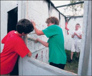 Nick Francis, left, helps Dylan Hanf and Cody Rutkowski work on Hell s Gate.