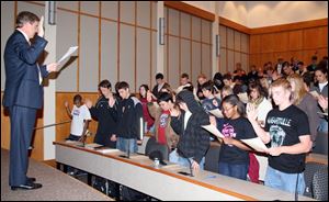 Ohio Supreme Court Justice Robert Cupp presides over the oath in the James. F. Dicke College of Business Administration.