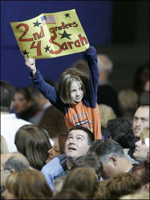 A youngster shows support for Sarah Palin during the
Republican vice presidential nominee s campaign stop at the University of Findlay. Mrs. Palin talked about the tax
plans of the Democrats during her visit to the area.
