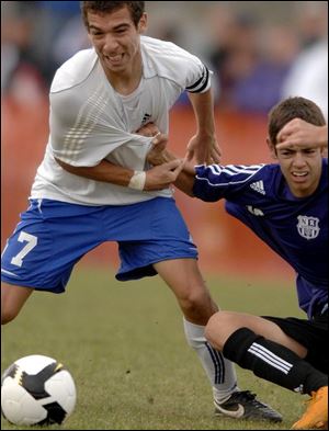 From left, Aaron Armstrong, Mac Church and Zach Tansel lead Anthony Wayne's celebration of a Division I regional title. Anthony Wayne's Aaron Armstrong, who scored the game's only goal, is pulled by North Royalton's Bobi Cancar.