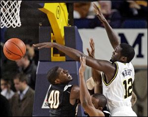 Michigan Tech forward Fedrick Bowe (40) watches the ball get knocked away from the basket by Michigan forward Anthony Wright in the first half of a regional round match of the 2K Sports Classic on Tuesday.