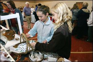 Slug: ROV harvestbazaar           Date: 11/8/2008             The Blade/Amy E. Voigt       Location: Toledo, Ohio  CAPTION:  Josie Iorio (cq), left, and Lauren Shawmaker, right, both from Ottawa Hils, look at lip balms that smell like fruits during the Epworth United Methodist Church's annual Harvest Bazaar on November 8, 2208. The event featured about 50 local and regional vendors selling handcrafted items, jewelry, candles and holiday goodies. All of the proceeds benefit charitable charities.