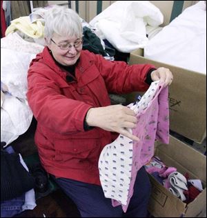 NBRW sale13p  11/08/2008     Blade Photo/Lori King  Toledoan Mary Kwiatkowski sort through clothes for her grandchildren to support the rummage sale to benefit student exchange program at Ottawa Hills High School.