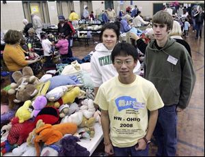 NBRW sale13p  11/08/2008     Blade Photo/Lori King  Exchange students Jasmina Laakso, from Finland, Chili resident Bowen Chen and Ottawa Hills student Nick Deluga volunteer at rummage sale to benefit student exchange program at Ottawa Hills High School.