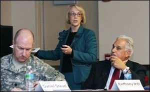 Mayor Jill Techel of Napa, Calif., shows slides of her city's effort to tame the Napa River. Yesterday's meeting included Lt. Col. Daniel Snead, left, commander of the Army Corps of Engineers' Buffalo District, and former Findlay Mayor Tony Iriti.