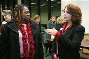 Toledo photographer Audrey Johnson, left, speaks with Julie Henahan, executive director of the Ohio Arts Council, after a public forum the state council held at the Sanger branch of the Toledo-
Lucas County Public Library to hear what northwest Ohioans want and appreciate in the arts.