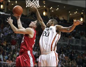 OSU's Jon Diebler goes up for a shot against Miami's Cyrus 
McGowan. Diebler hit six 3-pointers and scored a career-high 20.