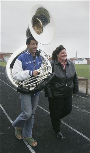 Springfield band director Kathleen McGrady helps Dylan Moore train.