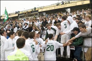 Ottawa Hills players celebrate with their fans after a 1-0 victory over Worthington Christian in Columbus gave the Green Bears the Division III state soccer title.