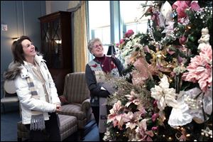 Toledoan Kaye Stephens, left, and Sue Cohen of Sylvania tour the displays at the 33rd annual 'Holidays in the Manor House.' 