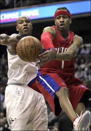 Washington s Caron Butler, left, defends the Pistons  Allen Iverson during the second quarter last night.