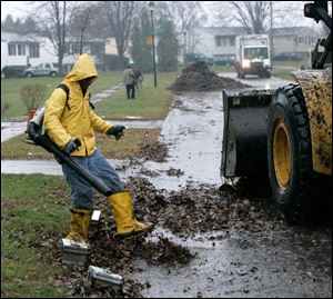 Norman Sharpley uses a leaf blower as part of a crew collecting leaves on Bloomfield Avenue. 
