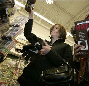 Jana Sharlow shops in a Pittsburgh-area craft store for yarn to make hats to give as Christmas presents. 
