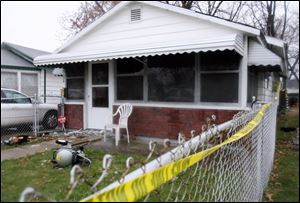 The body of Robert Porter, 60, was found inside this house at 350 West Andrus Rd. Mr. Porter, a carpenter at the University of Toledo, had been shot once in the head before someone set the home ablaze. Police said they do not know the relationship between Mr. Porter and Sarah Bunch, who has been charged in the case.