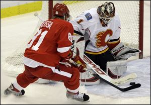 The Red Wings  Marian Hossa can t slip the puck past Flames goalie Curtis McElhinney.