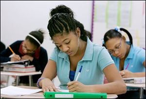 azmine Powell, 13, works on a letter in Millie Alvarez s class that asks Santa to cure a friend of cancer. The letters have to be in proper business form, have proper punctuation, and a have a wish for someone other than the letter writer, the teacher said.