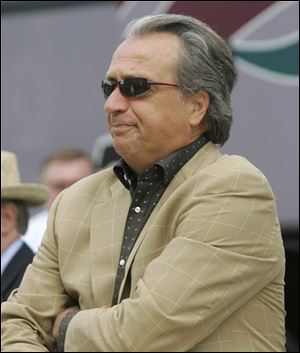 In this July 24, 2008, file photo, Kansas City Chiefs general manager Carl Peterson arrives for the NFL football team's training camp in River Falls, Wis.