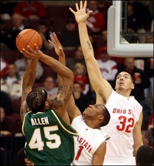Jacksonville s Marcus Allen (45) hoists a shot over the Buckeyes  Evan Turner and B.J.Mullens (32) last night in Columbus.