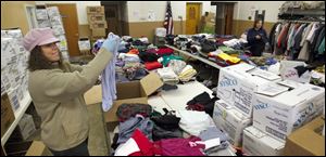 Barbie Rodriguez, left, and Annie Herman-Alrabaya unpack clothes for Operation Bread Basket. Donations can be dropped off at the Perrysburg Township office.
Operation bread Basket
