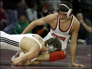 Cardinal Stritch s Josh Reindel, a two-time state qualifier and OWL champion, tries to escape from Otsego s Andrew Johnson.