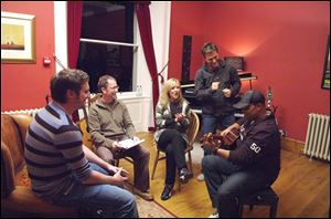 Christian songwriters Tim Hughes, left, Graham Kendrick, Darlene Zschech, Michael W.
Smith, and Israel Houghton compose and record songs for CompassionArt.