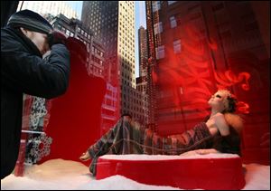 Saks Fifth Avenue, which assembled this display window in New York, is among upscale retailers that offered big discounts before the traditional start of the holiday shopping season.