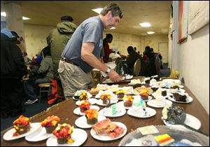 Local attorney Paul Geller sets out desserts for those attending the free holiday meal at Thomas Temple Church of God in Christ. Mr. Geller has donated food for the meal every year, and this year he contributed the meat.  Where there s a need, you ve got to do it,  Mr. Geller explained.  This is my Christmas gift to myself. Look at the smiling faces, look at the people you meet. 