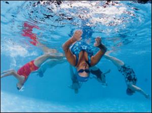 In the spirit of the Olympics this August, Nelgene Randall, 70, and
the rest of the Blue Dolphins synchronized swimmers spent much of their time underwater.
<br>
<img src=http://www.toledoblade.com/graphics/icons/photo.gif> <font color=red><b>VIEW</font color=red></b>: <a href=